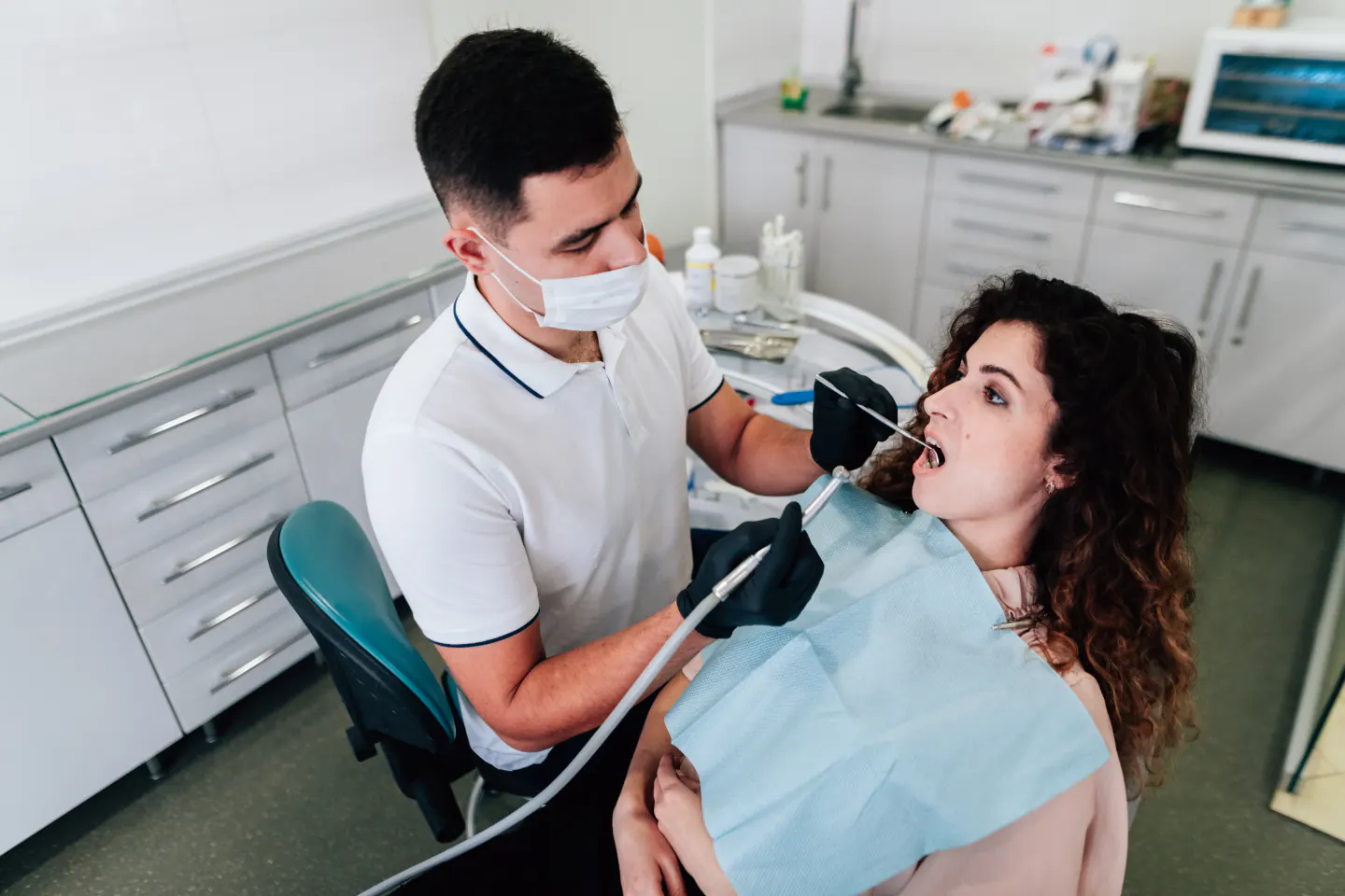 Dentist examining a patient in the chair